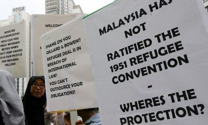 Malaysian human rights activists protest at a refugee swap ceremony between Australia and Malaysia