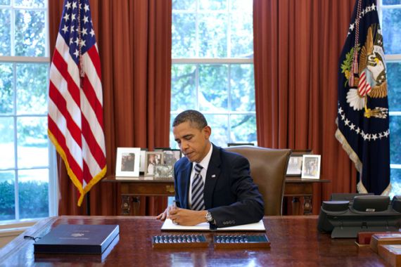 Obama signing White House debt ceiling bill in oval office