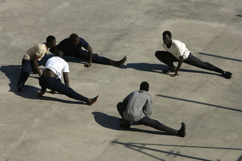 African immigrants exercise at a detention centre