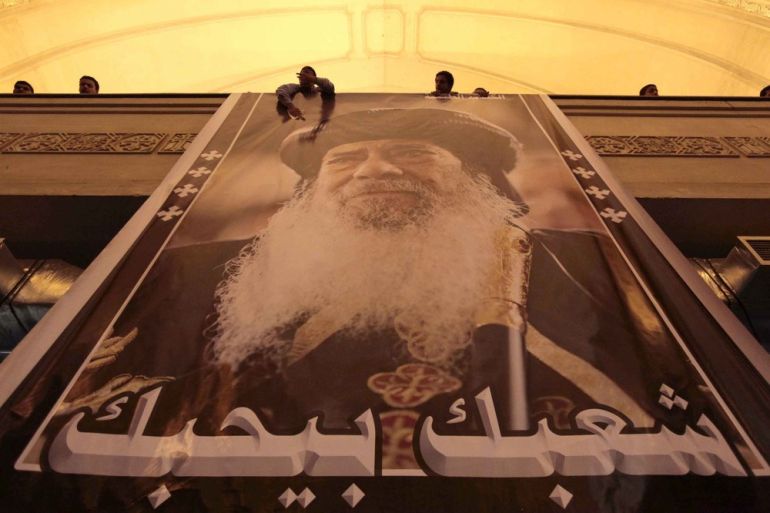 Egyptian Christian Copts mourn the death of Pope Shenouda III, the 117th Pope of the Coptic Orthodox Church of Alexandria and Patriarchof the See of St. Mark Cathedral (portrait) and reading " We Love You " at the main cathedral in Cairo