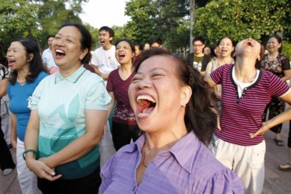 Members of the Laughter Yoga club practise laughing during morning exercise at a public park in Hanoi