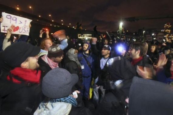Occupy Seattle protesters and union workers gather in a chanting circle at the University Bridge in Seattle
