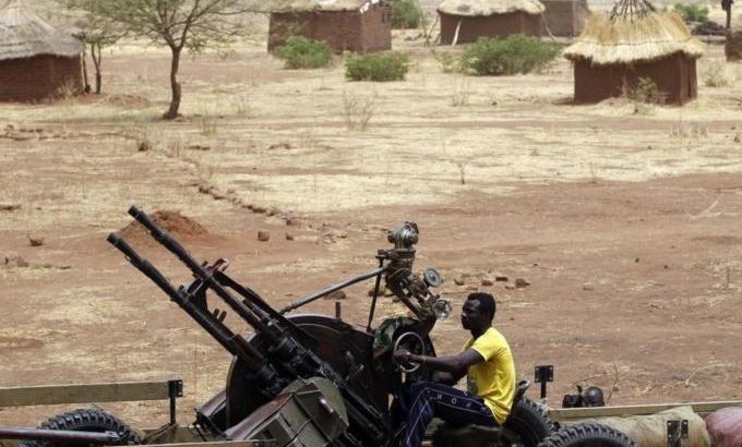 A SPLA-N fighter sits with an anti-aircraft weapon near Jebel Kwo village in the rebel-held territory of the Nuba Mountains in South Kordofan