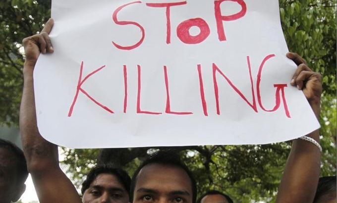 An ethnic Rohingya, from Myanmar and living in Malaysia, displays a placard during a rally against sectarian violence in Myanmar, in Kuala Lumpur