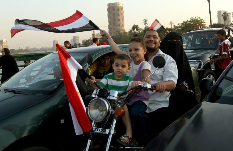 An Egyptian family, waving their nationa