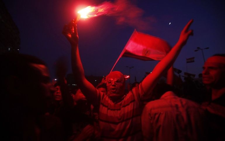 People fire flares to celebrate the victory of Muslim Brotherhood''s presidential candidate Mohamed Morsy in the election at Tahrir Square in Cairo