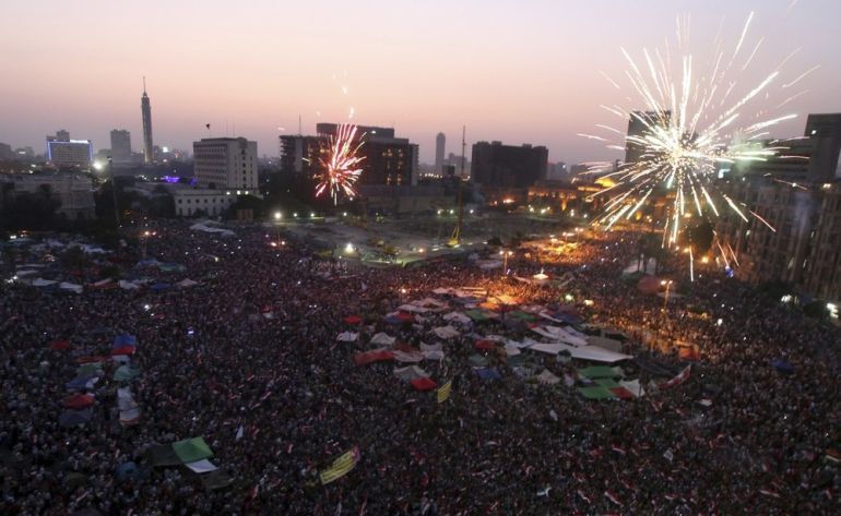 Fireworks explode as supporters of Muslim Brotherhood''s presidential candidate Mohamed Morsy celebrate his victory in the election at Tahrir Square in Cairo