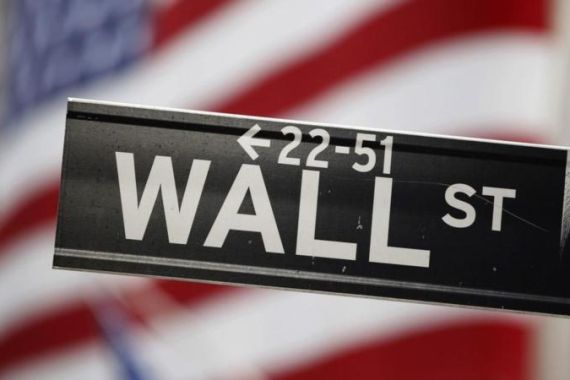 A street sign stands outside of the New York Stock Exchange on Wall Street in New York