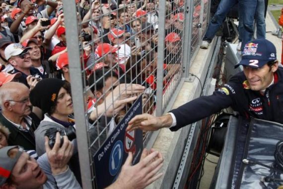Red Bull Formula One driver Mark Webber of Australia is greeted by fans after winning the British F1 Grand Prix at Silverstone
