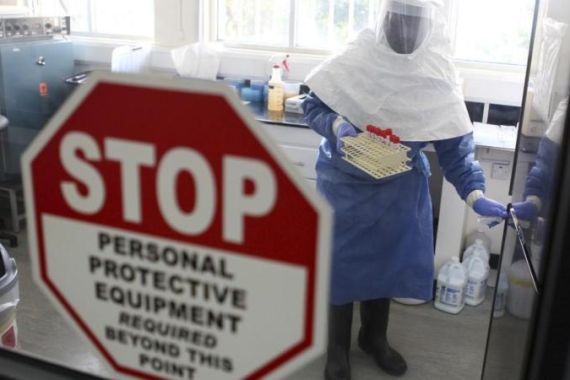 A doctor works in a laboratory on collected samples of the Ebola virus at the Centre for Disease Control in Entebbe