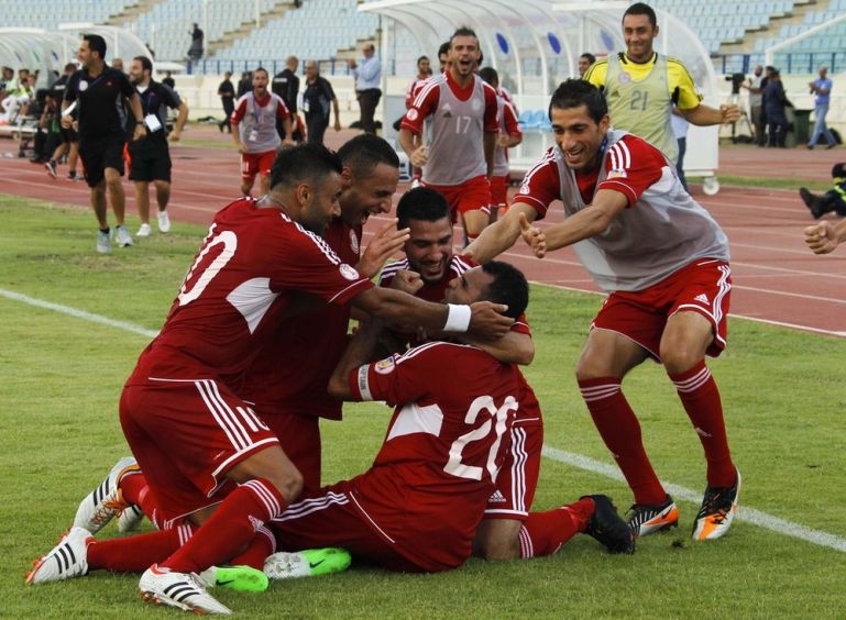 Lebanon''s players celebrate their win against Iran in their 2014 World Cup qualifying soccer match in Beirut