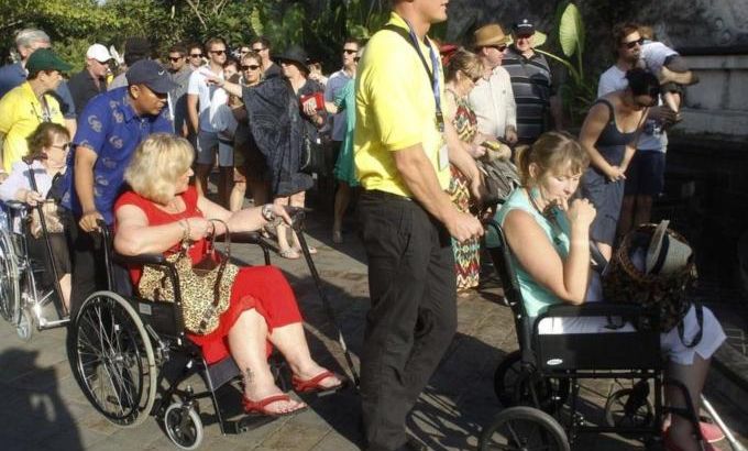 Survivors of the 2002 Bali bomb blast are pushed in on wheelchairs for the commemoration service for the 10th anniversary of the Bali bombing in Garuda Wisnu Kencana (GWK) cultural park in Jimbaran