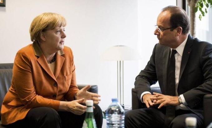 German Chancellor Merkel talks with French President Hollande ahead of an EU summit in Brussels