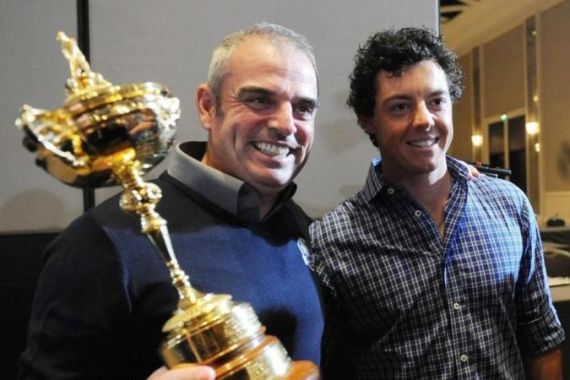 McGinley of Ireland poses with the Ryder Cup while flanked by McIlory of Northern Ireland during a news conference after McGinley was named the European Ryder Cup captain at the St. Regis in Saadiyat Islands in Abu Dhabi