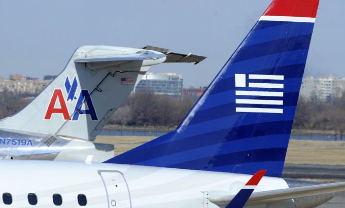 A US Airways Express plane (R) moves on the tarmac as an American Airlines plane is parked at the Ronald Reagan Washington National Airport in Arlington County, Virginia, in this February 10, 2013, file photo.