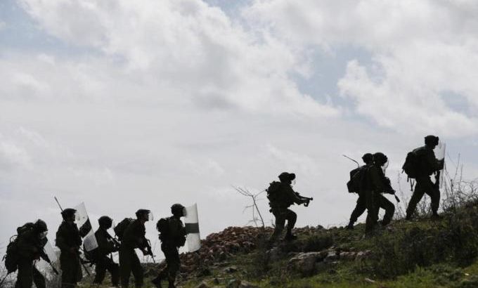 Israeli border policemen climb a hill during clashes with stone-throwing Palestinian protesters near Ramallah
