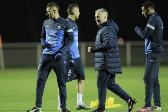 France''s soccer coach Deschamps walks next to Benzema during a training session atinClairefontaine, near Paris