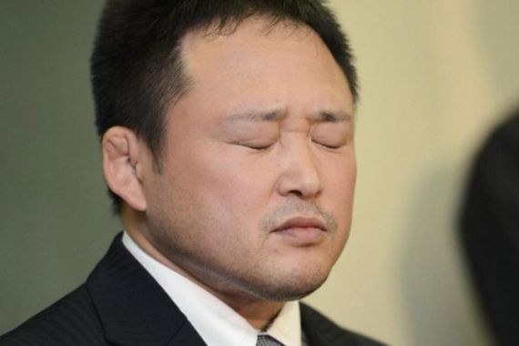 Japanese women''s Judo coach Sonoda closes his eyes during a news conference in Tokyo