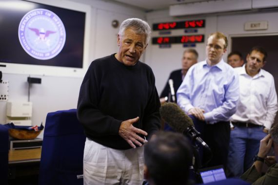 U.S. Defense Secretary Chuck Hagel speaks to the travelling press aboard his military aircraft between Andrews Air Force Base and Afghanistan