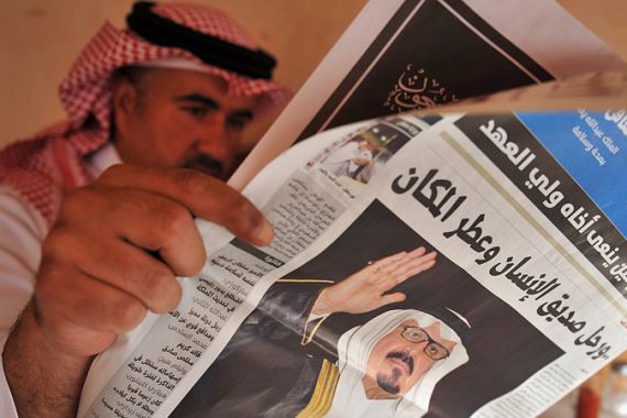 A Saudi man reads a newspaper