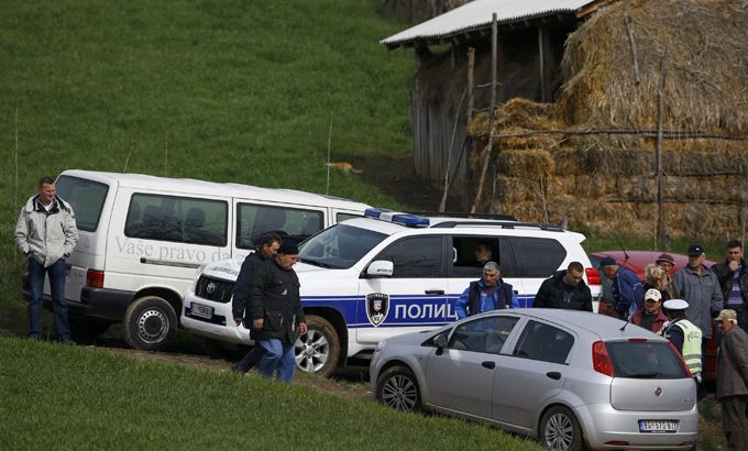 Police and residents are pictured in the village of Velika Ivanca,