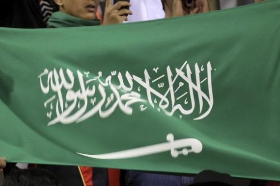 Saudi Arabia fans wave their country''s flag as they cheer their team during the soccer match against Jordan at the FUCHS four-nation tournament in Amman