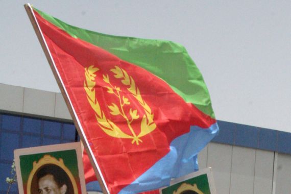 ritreans living in Sudan wave the Eritrean flag