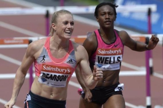 Sally Pearson of Australia reacts next to third-placed Kellie Wells of the United States after winning the women''s 100m hurdles at the London Diamond League ''Anniversary Games'' athletics meeting in east London