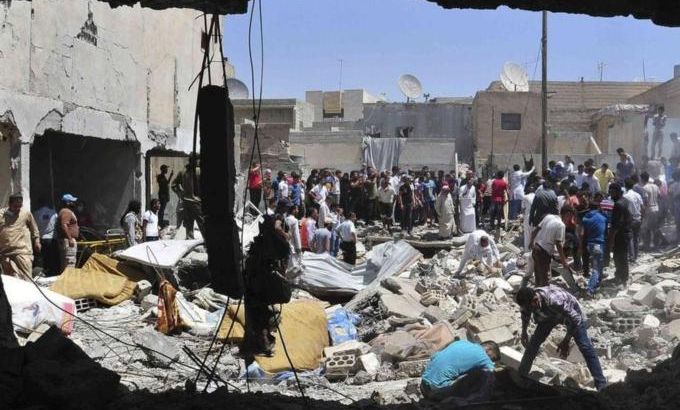 Men search for survivors amid debris of collapsed buildings after what activists said was an air raid by forces loyal to Syria''s President Bashar al-Assad in Raqqa province, eastern Syria