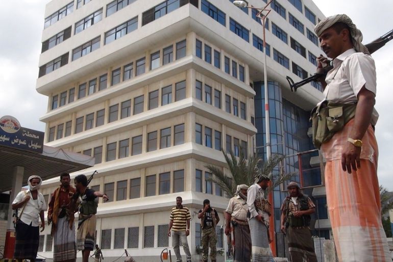 Members of the so-called Popular Resistance Committees (PRC) guard a building in South Yemen