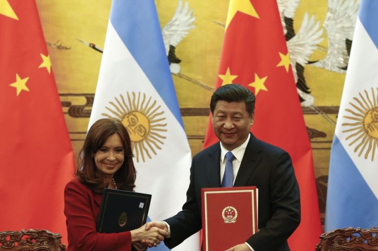 Argentinian President Kirchner and Chinese President Xi shake hands and face the media after signing documents during a ceremony at the Great Hall of the People in Beijing