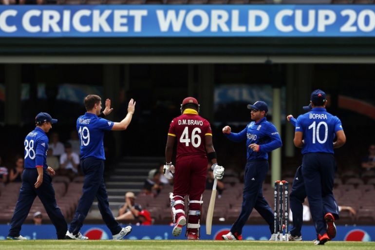 Woakes of England celebrates with team mates after he dismissed Bravo of the West Indies for a first-ball duck during their warm-up match at the Sydney Cricket Ground