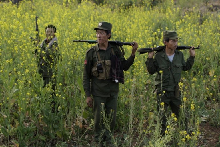 Rebel soldiers of Myanmar National Democratic Alliance Army (MNDAA) patrol near a military base in Kokang region