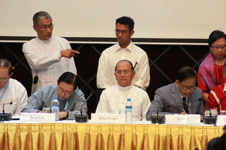 Myanmar President Thein Sein is seated at center while representatives of the government and armed ethnic groups sign an agreement on the draft of a nationwide cease-fire agreement,