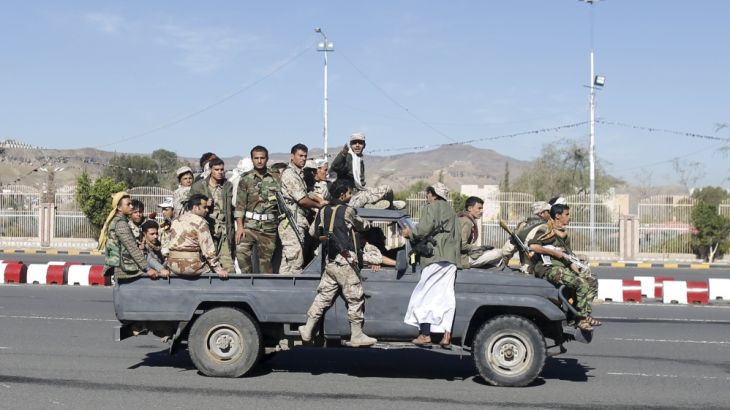 Houthi fighters ride a patrol truck in Sanaa