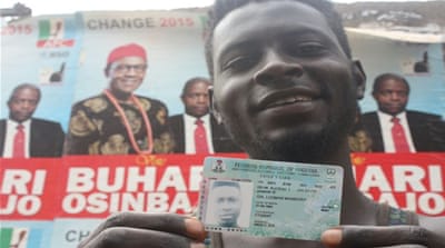 A Nigerian voter from troubled Jos shows off his voter card [Chika Oduah/Al Jazeera] 