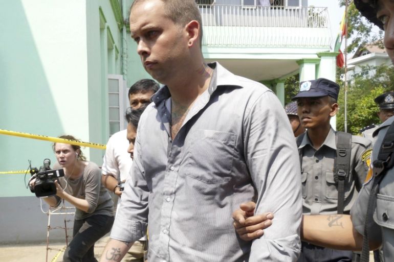 Gastro bar, is escorted by Myanmar police officers on his arrival at a township court Tuesday,