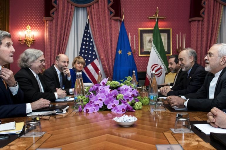 U.S. Secretary of State John Kerry, U.S. Secretary of Energy Ernest Moniz, Head of the Iranian Atomic Energy Organisation Ali Akbar Salehi and Iranian Foreign Minister Javad Zarif wait with others in