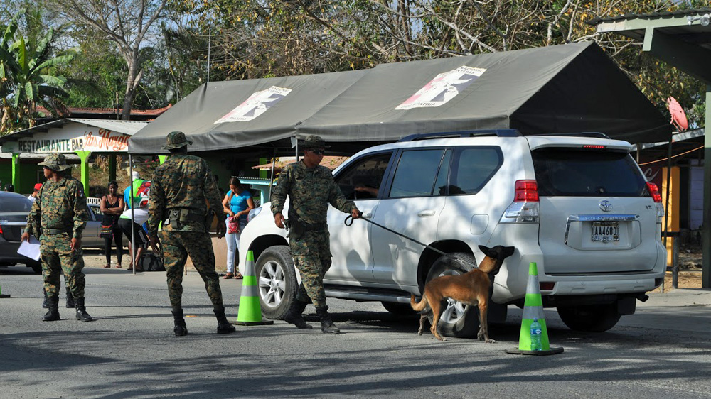 A sniffer dog at a border police checkpoint at Agua Frida on the Pan-American Highway [Joe Jackson/Al Jazeera]