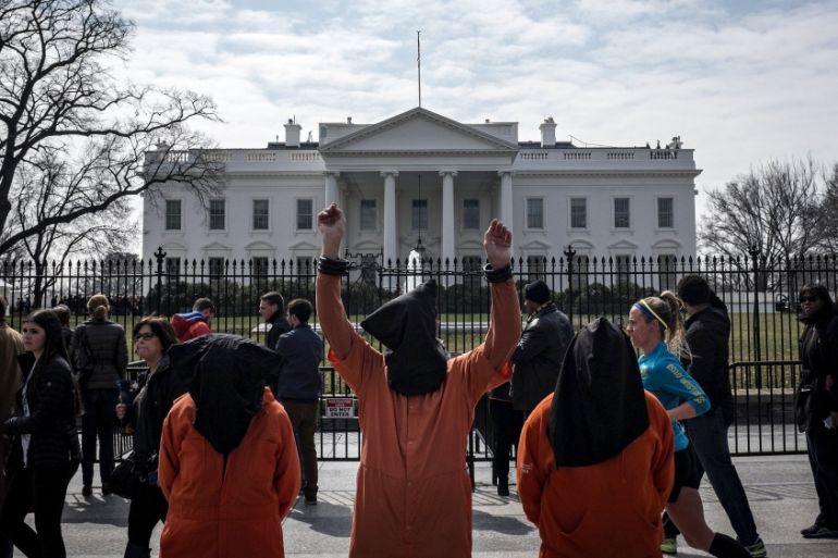 Protesters dressed as Guantanamo Bay prisoners take part in an anti-war demonstration [Reuters]