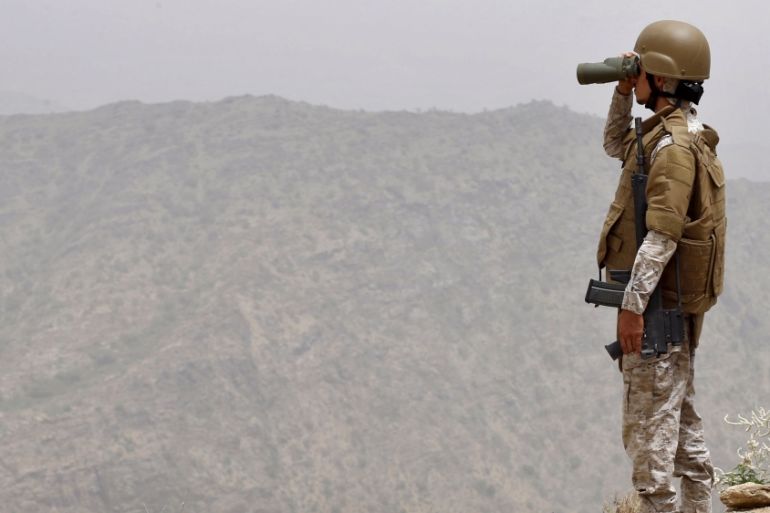 A Saudi soldier looks through binoculars at Saudi Arabia''s border with Yemen [REUTERS]