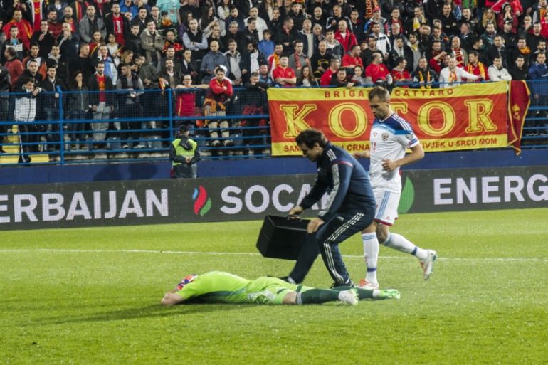 Russia''s Igor Akinfeev hit by flare at Montenegro, match later abandoned
