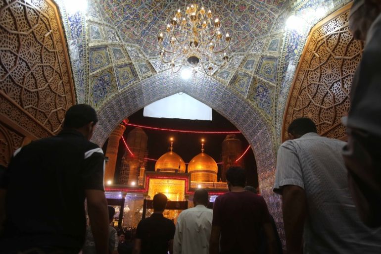 Shia pilgrims pray at the Imam Mousa al-Kazim shrine
