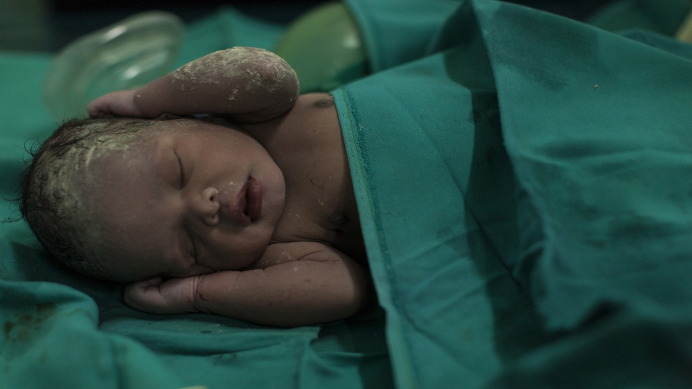 A baby girl born just seconds earlier recovers from asphyxiation after her mother received an emergency caesarian section [Adriane Ohanesian] 