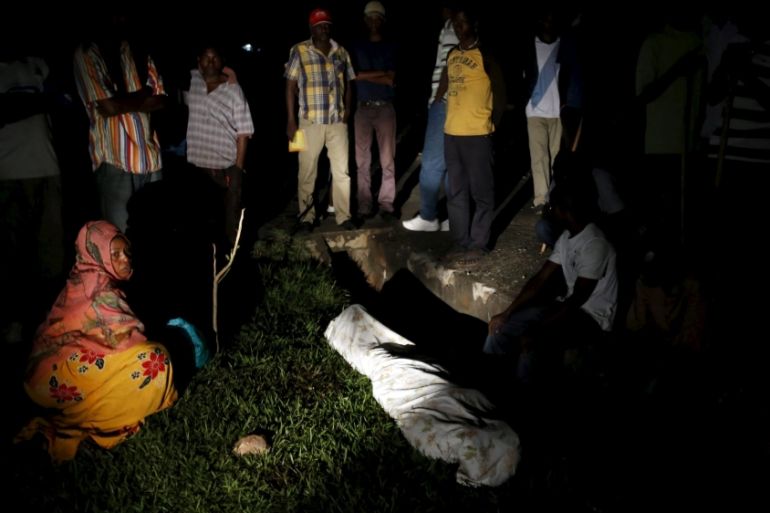 Relatives and friends gather around the covered body of Zedi Feruzi, the head of opposition party UPD, in Bujumbura, Burundi