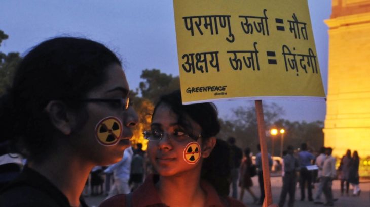 Greenpeace activists hold placards as they participate in a candle light vigil near the India Gate war memorial in New Delhi, India in 2011