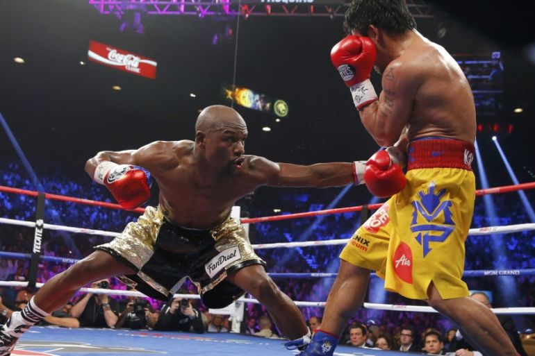 Mayweather, Jr. of the U.S. stays low against Pacquiao of the Philippines
