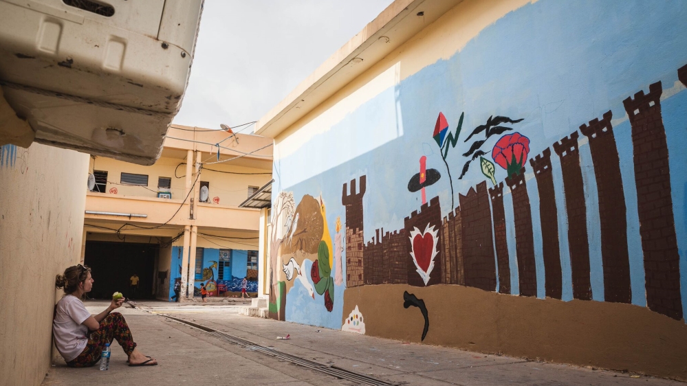 
Some of the most recent murals to appear on the camp's walls show the influence of street artist Banksy [Andrea DiCenzo/Al Jazeera]
