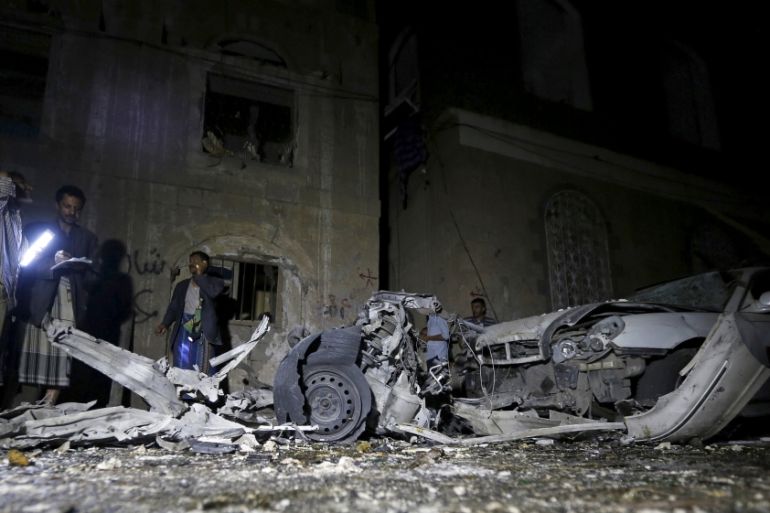 Police officers inspect the site of a car bomb attack in Yemen''s capital Sanaa
