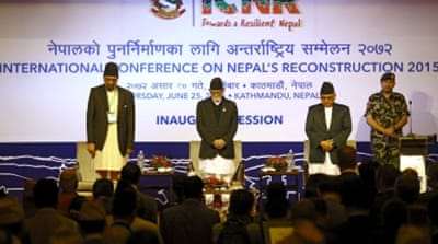 Nepal's prime minister along with the ministers of finance and foreign affairs observe a minute of silence in memory of earthquake victims during the conference in Nepal [REUTERS]